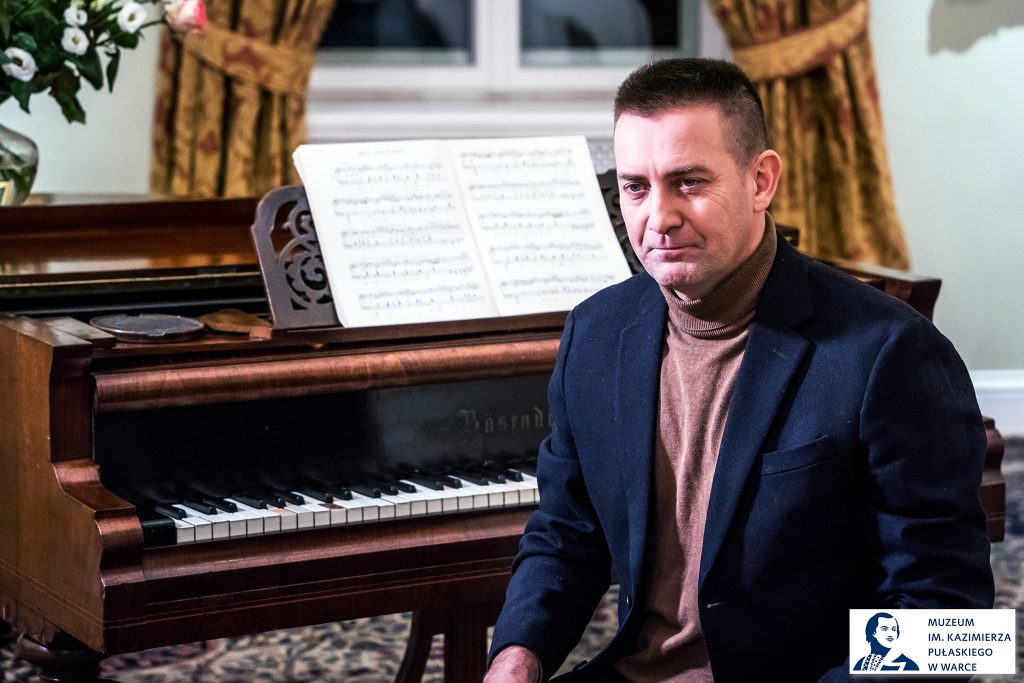 mężczyzna siedzący przy fortepianie