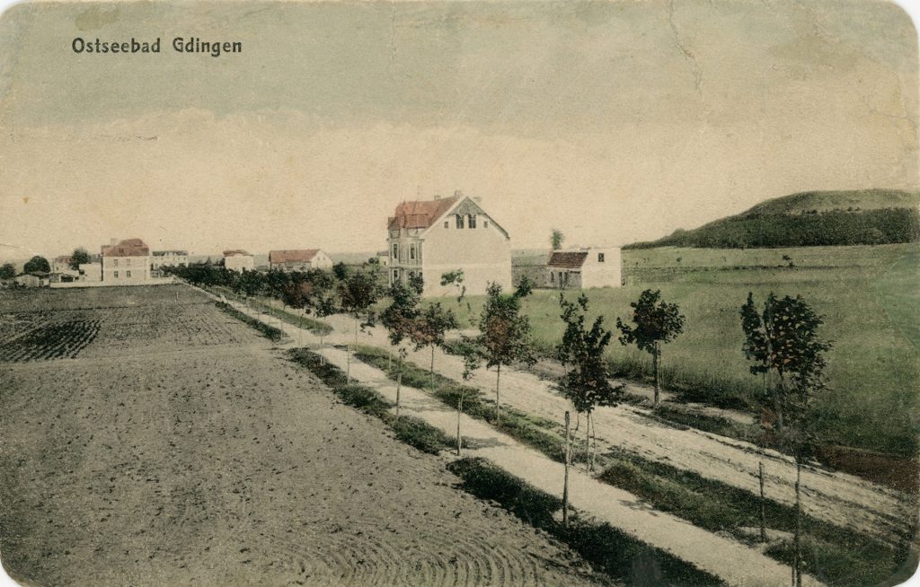 pocztówka z drogą i domkiem po prawej stronie