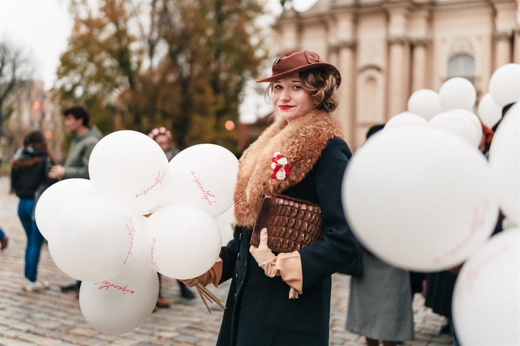 rekonstruktorka historyczna trzymająca balony z napisem "niepodległa"